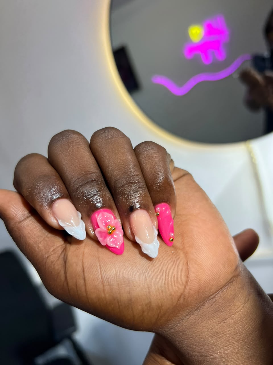 Almond nails in hot pink and white French with 3D pink flower and gold bead accents