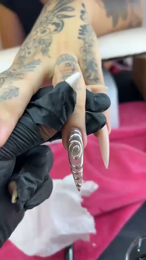 Long stiletto nail with 3D silver chrome swirl